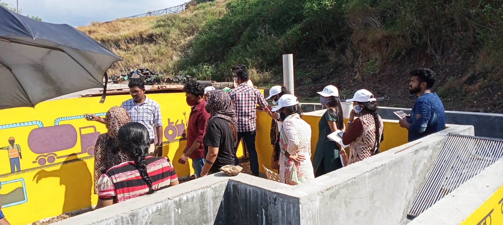 Participants observing the Mobile Faecal Sewage Treatment Plant